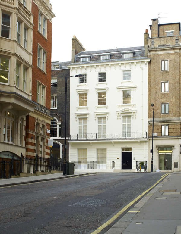 David Zwirner gallery's white townhouse exterior on a quiet London street, flanked by red and beige brick buildings