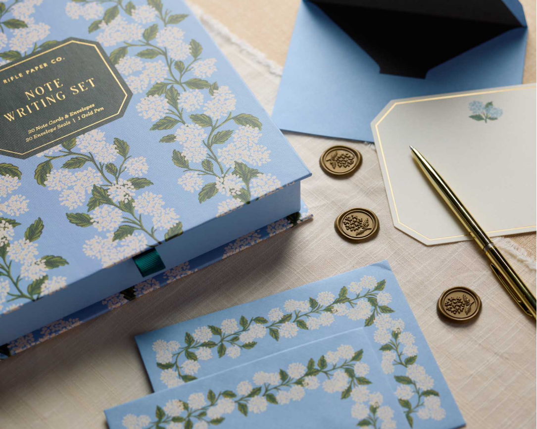 Rifle Paper Co. Note Writing Set with blue hydrangea box, note cards, envelopes, gold pen and wax seals