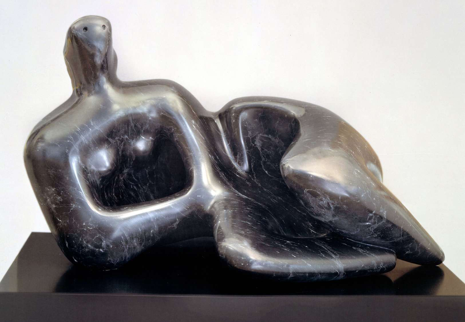 Abstract reclining female figure in polished dark veined marble on plinth, Fine Arts Paris 2026